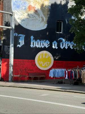 A street with a sign on the side of a building

AI-generated content may be incorrect.