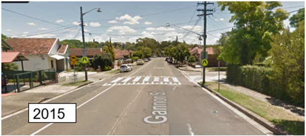 A street with cars and trees
AI-generated content may be incorrect.