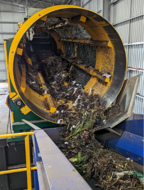 A yellow and green machine with a yellow circular object with debris inside

AI-generated content may be incorrect.