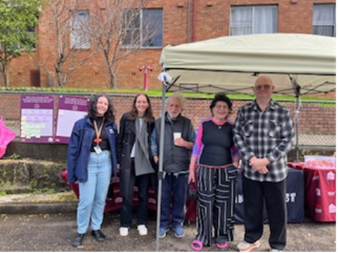 A group of people standing under a tent

AI-generated content may be incorrect.