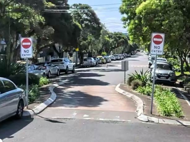 A street with cars parked on the side

AI-generated content may be incorrect.